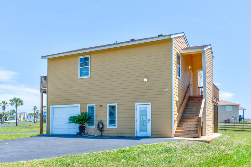 Front of the house with the garage and stairs up to the main floor