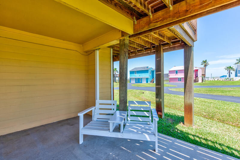 Shaded patio with chairs under the house