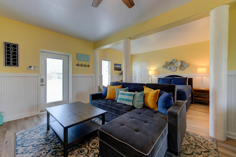 First-floor sofa with the queen bed beyond