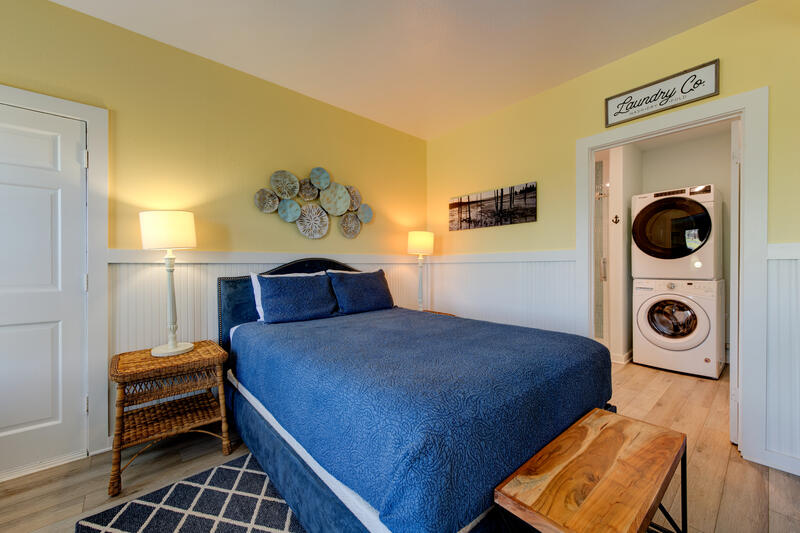 First-floor queen bed with the laundry room beyond
