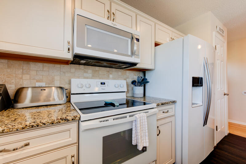 Kitchen with range and refrigerator