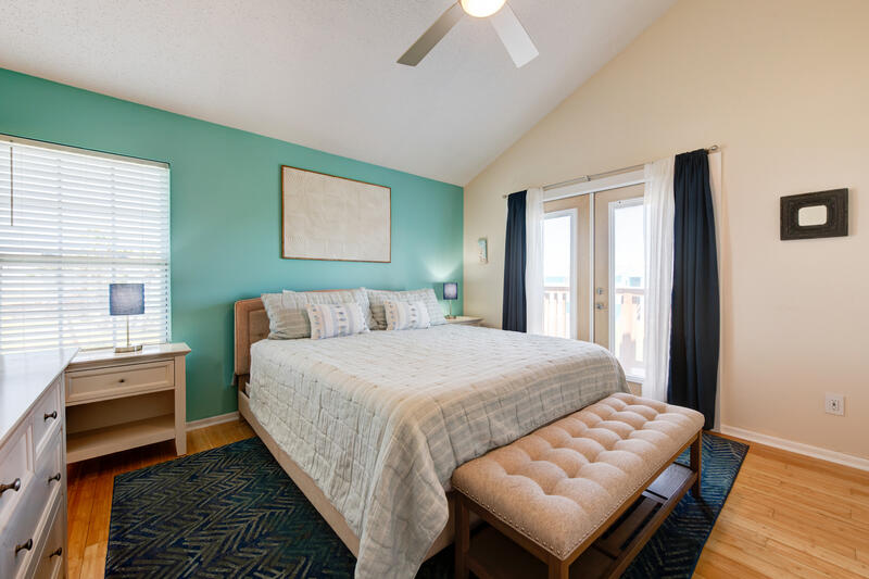 Bedroom with king bed and doors to the deck