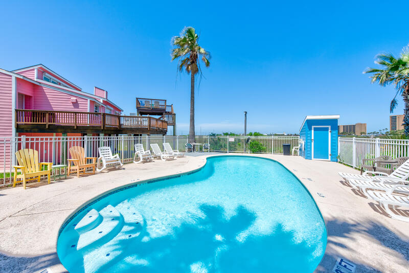 Community pool and colorful neighboring houses