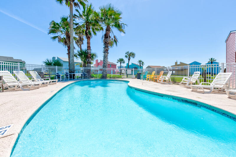 Community pool deck with lounge chairs